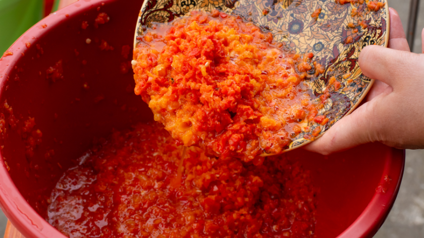 pouring paprika into a bowl